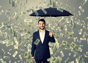 smiley glad businessman with umbrella standing under money rain